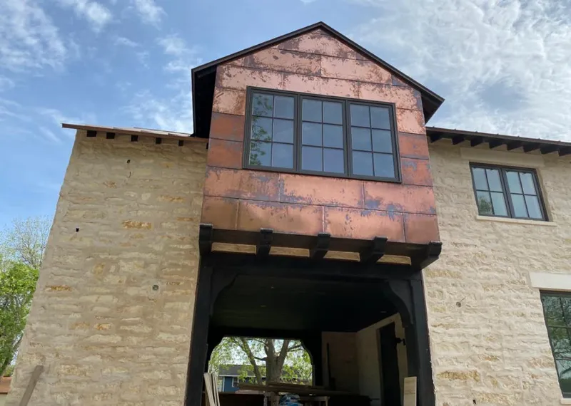 Copper metal panel facade on a stone building for Skylight Installation in Austell
