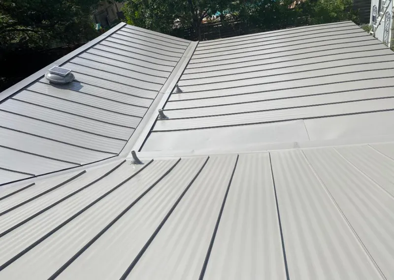 Solar attic fan installed on a metal roof for Roof Ventilation in Austell